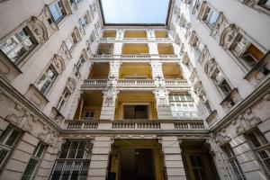 a tall building with yellow doors and windows at Short Trips Apartment in Budapest