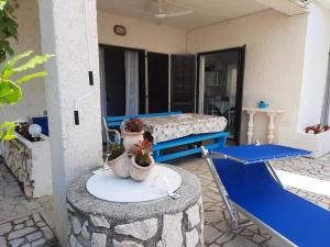 a room with a bed and a table with flowers on it at Apartment Lili in Lukovo +49 photos