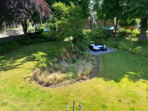 a garden with a bench in the grass at Glen Lyon Lodge Bed and Breakfast in Nairn