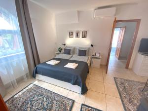 a small bedroom with a bed and a window at Villa Lillybeth - Lake Balaton in Keszthely