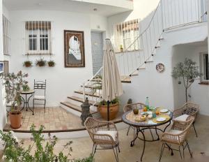 patio ze stołem i krzesłami oraz schodami w obiekcie CASA AMARO w mieście Vejer de la Frontera