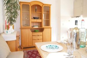 a kitchen with a wooden hutch and a table at Alpen Apartments Salzburg in Lessach