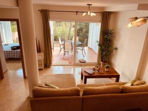 a living room with a couch and a table at Arenal Dream Javea, luxury beach apartment in Jávea