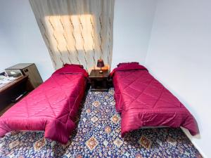 a small bedroom with two beds in a room at west view hostel in ‘Ayn Amūn