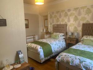 a bedroom with two beds in a room at Seamore House in Moffat
