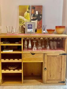 a wooden cabinet filled with lots of glass vases at Apartamento Playa Arrabassada in Tarragona