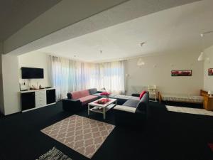 a living room with a couch and a table at Apartmány Superrelax in Liptovský Mikuláš