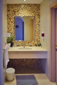 a bathroom with a sink and a mirror at Chic/Elegant 4 Bedrooms… in Jeddah