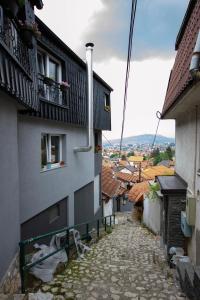 an alley with a building and a bench on the side at View in Sarajevo
