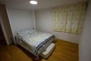 a small bedroom with a bed and a window at View in Sarajevo