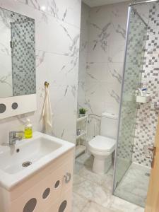 a bathroom with a sink and a toilet and a shower at Studio SvEt 39 in Mohammedia +14 photos
