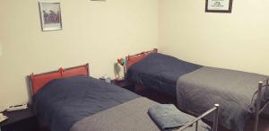 a room with two beds in a room at L'Eau Berge - Relais Motards - GTMC & Tour des Vaches B&B in Allanche