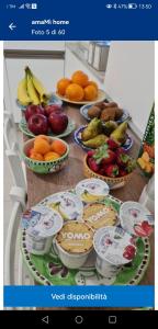 a table with bowls of fruit and plates of food at amaMì home in Vietri