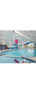 a large swimming pool with blue water at Luxury spacious family caravan in Edinburgh
