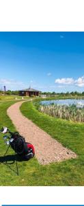 a bike parked on the grass next to a dirt road at Luxury spacious family caravan in Edinburgh