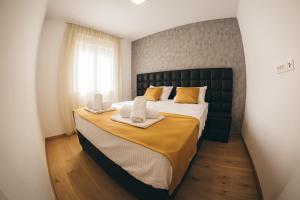 a bedroom with a large bed with two towels on it at Family apartment Mirjam in Orebić