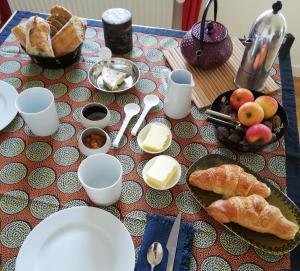 a table with a plate of food and bread on it at Entre en Baie ! in Pontaubault