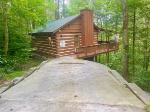 a cabin in the woods with a ramp leading to it at Bearadise in Townsend