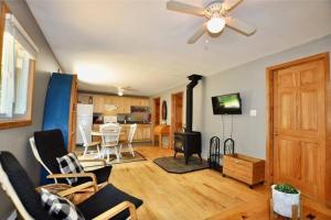 a living room with a couch and a ceiling fan at Muskoka Manor in Dwight