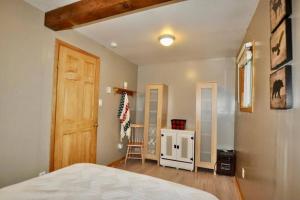 ein Schlafzimmer mit einem Bett, einem Schrank und einer Tür in der Unterkunft Muskoka Manor in Dwight
