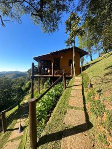 a house on a hill with a pathway leading to it at Pousada A Rosa e o Rei in São Francisco Xavier
