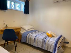 a bedroom with a bed and a desk and a chair at Villa Lemonia in Malia +26 photos