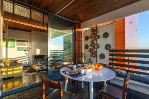 a dining room with a table and a living room at Atlantic Views Luxury Retreat in Estoril