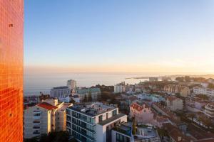 an aerial view of a city with the ocean at Home with a view in Estoril