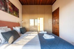 a bedroom with a bed with two towels on it at Atlantic Views Luxury Retreat in Estoril