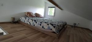 a bedroom with a bed in a room with a window at La Petite Maison in Saint-Rémy-lès-Chevreuse