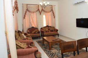 a living room with two couches and a table at Red-37 - Bn Breek Villa in Salalah