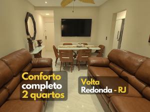 uma sala de estar com um sofá e uma sala de jantar em Apartamento ótimo padrão volta redonda em Volta Redonda
