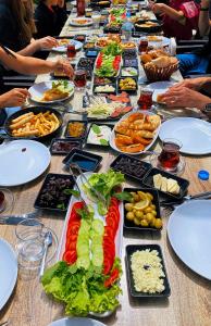 a long table filled with plates of food on it at Calina Hotel in Uchisar