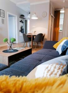 a living room with a couch and a table at Shine Apartman in Szentgotthárd