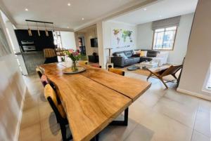 una cucina e un soggiorno con tavolo in legno di Villa Terre d'Albion ad Albion