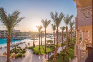 a view of a resort with palm trees and a pool at Pickalbatros Palace - Aqua Park Hurghada in Hurghada