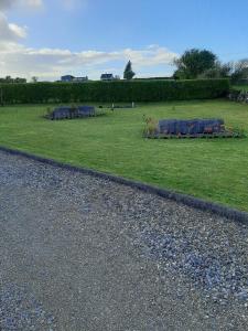 a field of grass with a table with flowers at Ballytigue House in Droíchead an Chláir