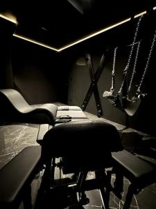 a room with a hair salon with two chairs andweapons at BDSM TanTra Love Room & SPA in Miramas