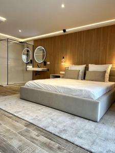 a large bedroom with a large bed with two mirrors at BDSM TanTra Love Room & SPA in Miramas