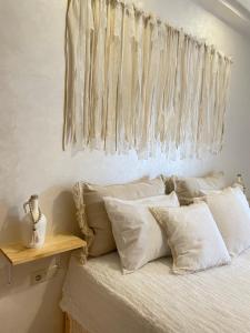 a bedroom with a bed with white pillows at Studio SvEt 19 in Mohammedia