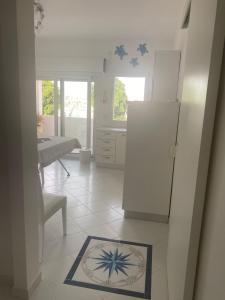 a kitchen with a refrigerator and a table in it at La Salina in Lampedusa