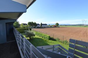 - une vue sur un champ de ferme depuis la terrasse couverte d'une maison dans l'établissement Kyriad Tarbes Odos, à Odos