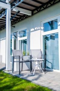 a patio with two chairs and a table at Pensjonat VICTORIA in Ustka