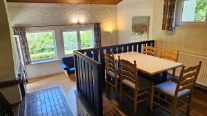 a dining room with a table and chairs at Landhaus Wald und See Nr. 35 in Biersdorf