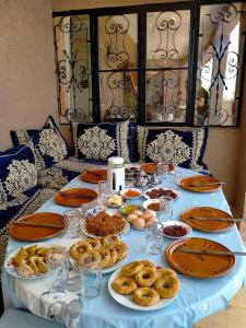 a blue table with plates of food on it at Gite Gliz in Marrakech