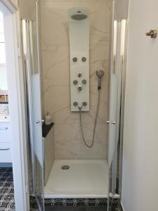 a bathroom with a shower with a glass door at HR Stadtwald Villa Honigbach in Coesfeld