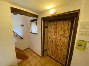 un bagno con porta in legno e corridoio di Appartement village médiéval a Parnac
