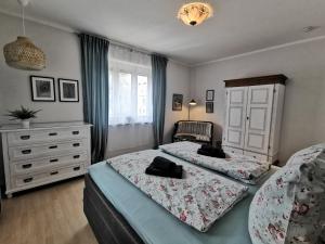a bedroom with two beds and a dresser at HR Stadtwald Villa Honigbach in Coesfeld