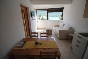 a living room with a table and a couch at Villa Hortus in Neum