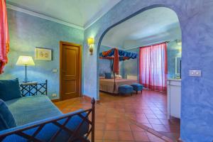 a room with a bedroom with a bed and a room with a bed sqor at La Casa delle Monache Country Resort in Motta Camastra